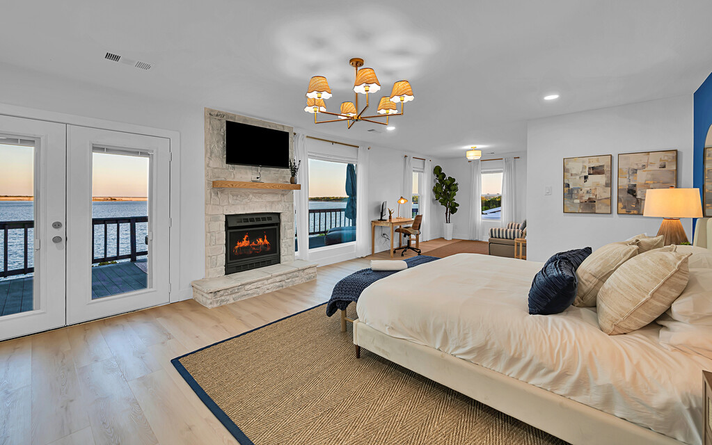 Master suite — fireplace, TV and lake view from bed
